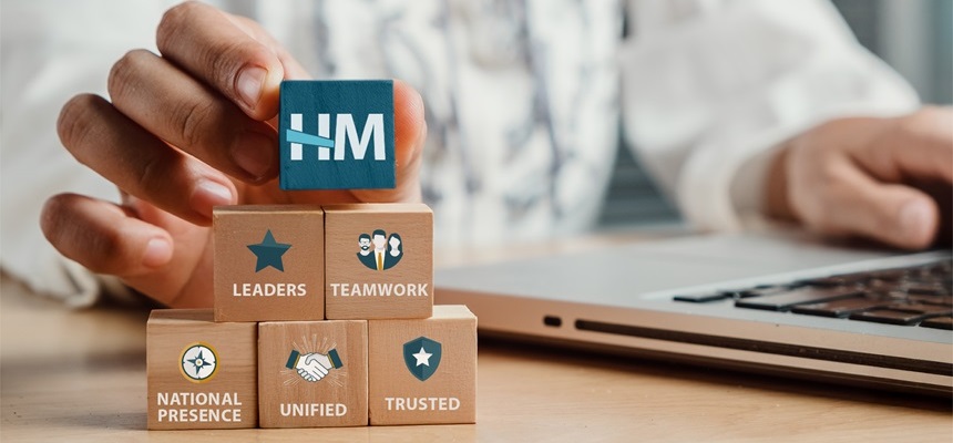 Image representing the building blocks of the HM Insurance Group brand: strong leadership, teamwork, and a unified, trusted national presence