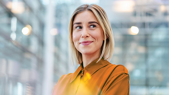 A young adult professional stands confidently, representing the innovative and protective solutions that HMConnects™ offers to safeguard clients from catastrophic medical expenses.