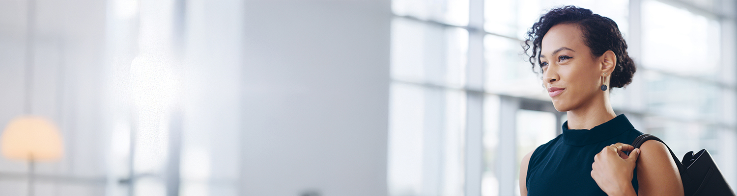 A young adult professional looks confidently ahead, representing HM Insurance Group's forward-thinking approach to providing financial risk protection.