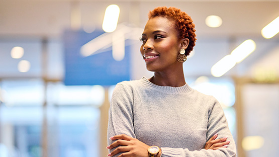 A smiling young adult with folded arms confidently looks to the side, representing a solid and understandable contract.
